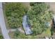 A heavily treed aerial view of a single story house with a gray roof at 1317 Old Polk City Rd, Lakeland, FL 33809