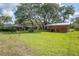 Expansive backyard with lush grass and a detached brick building at 1317 Old Polk City Rd, Lakeland, FL 33809