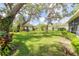 Spacious backyard with a detached garage surrounded by lush greenery at 1317 Old Polk City Rd, Lakeland, FL 33809