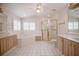 Bright bathroom featuring a corner tub, glass enclosed shower, and tiled floor at 1317 Old Polk City Rd, Lakeland, FL 33809