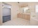 Large bathroom featuring white tile, and vanity with adjoining tub and a glimpse into a bedroom at 1317 Old Polk City Rd, Lakeland, FL 33809