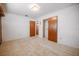 Bedroom featuring neutral carpet and white walls, doors to closet and bathroom at 1317 Old Polk City Rd, Lakeland, FL 33809