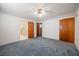 Bedroom featuring blue carpet with adjoining bathroom and closet at 1317 Old Polk City Rd, Lakeland, FL 33809