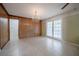 Light and open dining room with wood-paneled accent wall and chandelier at 1317 Old Polk City Rd, Lakeland, FL 33809