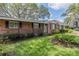 Beautiful brick home featuring manicured lawn and front porch at 1317 Old Polk City Rd, Lakeland, FL 33809
