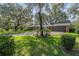 Lovely brick house with an attached garage surrounded by lush greenery at 1317 Old Polk City Rd, Lakeland, FL 33809