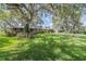 Classic brick home with lush lawn and mature trees providing shade at 1317 Old Polk City Rd, Lakeland, FL 33809
