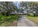 Charming brick home with mature trees and a long driveway at 1317 Old Polk City Rd, Lakeland, FL 33809