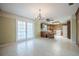 Spacious kitchen area with wood cabinets, tile floors, and a chandelier enhancing the dining space at 1317 Old Polk City Rd, Lakeland, FL 33809