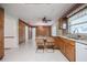 Charming kitchen features wood cabinets, tile flooring, and an adjacent dining area with natural light at 1317 Old Polk City Rd, Lakeland, FL 33809