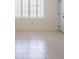 Bright living room with tile floors, white walls, and shuttered windows, showcasing its inviting atmosphere at 1317 Old Polk City Rd, Lakeland, FL 33809