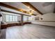 Large living room with ceiling fan and fireplace, accentuated by decorative wooden ceiling beams at 1317 Old Polk City Rd, Lakeland, FL 33809