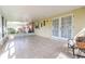 Relaxing screened porch with tile flooring, ceiling fan, and views of the backyard greenery at 1317 Old Polk City Rd, Lakeland, FL 33809