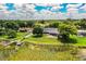 Aerial view of a beautiful home with a screened-in pool, a large yard and waterfront access at 1328 Edgewater Beach Dr, Lakeland, FL 33805
