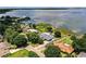 Aerial view of lakefront homes surrounded by lush greenery and a beautiful lake at 1328 Edgewater Beach Dr, Lakeland, FL 33805