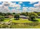 Aerial view of a home with screened in patio, large yard and access to the waterfront at 1328 Edgewater Beach Dr, Lakeland, FL 33805