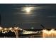 Beautiful lake view at night with string lights for a relaxing ambiance at 1328 Edgewater Beach Dr, Lakeland, FL 33805