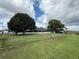 Spacious backyard with mature trees, lush green grass and chain link fence at 1328 Edgewater Beach Dr, Lakeland, FL 33805