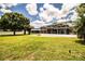 Expansive backyard with a screened patio and charming fire pit, perfect for entertaining outdoors at 1328 Edgewater Beach Dr, Lakeland, FL 33805