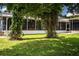 Green backyard with vines and a screened patio featuring a hot tub for relaxation at 1328 Edgewater Beach Dr, Lakeland, FL 33805