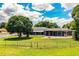 Spacious backyard featuring a screened-in patio with fenced yard and grass at 1328 Edgewater Beach Dr, Lakeland, FL 33805