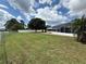 Large backyard with a mature shade tree, screened patio and lake views at 1328 Edgewater Beach Dr, Lakeland, FL 33805