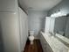Bathroom with a vanity, toilet and a shower with patterned curtain at 1328 Edgewater Beach Dr, Lakeland, FL 33805