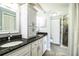 Bathroom with double vanity, dark countertops and white cabinets at 1328 Edgewater Beach Dr, Lakeland, FL 33805
