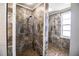 Stunning walk-in shower with brown stone tile and dual shower heads at 1328 Edgewater Beach Dr, Lakeland, FL 33805