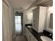 Bathroom featuring a double vanity with granite countertops and white cabinets, offering a bright, modern feel at 1328 Edgewater Beach Dr, Lakeland, FL 33805