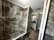 Walk-in shower with marble look tile at 1328 Edgewater Beach Dr, Lakeland, FL 33805