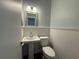 Charming half bathroom featuring updated vanity, lighting, and wall trim at 1328 Edgewater Beach Dr, Lakeland, FL 33805