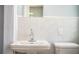 Bathroom featuring a pedestal sink, a standard toilet and tiled walls at 1328 Edgewater Beach Dr, Lakeland, FL 33805