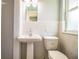 Bathroom with white tile, pedestal sink, and a window at 1328 Edgewater Beach Dr, Lakeland, FL 33805