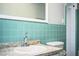 Brightly tiled bathroom with a large mirror, a granite sink, and a toilet at 1328 Edgewater Beach Dr, Lakeland, FL 33805
