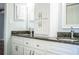 Double vanity bathroom with white cabinets, dark countertops and modern fixtures at 1328 Edgewater Beach Dr, Lakeland, FL 33805