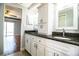 Bathroom with double sink vanity, granite countertop, and white cabinets at 1328 Edgewater Beach Dr, Lakeland, FL 33805