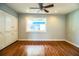 A bright bedroom featuring hardwood floors, a ceiling fan, and a built-in wardrobe at 1328 Edgewater Beach Dr, Lakeland, FL 33805