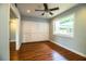 A bright bedroom featuring hardwood floors, a ceiling fan, and a built-in wardrobe at 1328 Edgewater Beach Dr, Lakeland, FL 33805