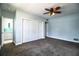 Carpeted bedroom with a ceiling fan, a large closet, and a glimpse into the Primary bathroom at 1328 Edgewater Beach Dr, Lakeland, FL 33805