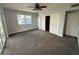 Spacious bedroom with ceiling fan, carpet, walk-in closet, and ample natural light at 1328 Edgewater Beach Dr, Lakeland, FL 33805