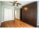 This bedroom features wood floors, a ceiling fan, a closet, and a murphy bed at 1328 Edgewater Beach Dr, Lakeland, FL 33805