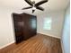 This bedroom offers a Murphy bed, shelving, and a ceiling fan at 1328 Edgewater Beach Dr, Lakeland, FL 33805
