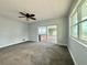 Bedroom showcasing neutral walls, ceiling fan and sliding door to porch at 1328 Edgewater Beach Dr, Lakeland, FL 33805