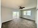 Bedroom with ceiling fan and carpet floors, features access to the outside patio at 1328 Edgewater Beach Dr, Lakeland, FL 33805