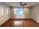 Spacious bedroom with hardwood floors, storage closet, and large window at 1328 Edgewater Beach Dr, Lakeland, FL 33805