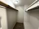 Walk-in closet with shelving on both sides and tile floor at 1328 Edgewater Beach Dr, Lakeland, FL 33805