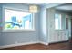 Open concept room with hardwood floors, modern lighting, and large windows at 1328 Edgewater Beach Dr, Lakeland, FL 33805
