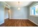 Bright dining room with hardwood floors, large window, and neutral paint at 1328 Edgewater Beach Dr, Lakeland, FL 33805