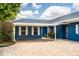 Beautiful blue single-story home featuring a brick driveway and covered carport at 1328 Edgewater Beach Dr, Lakeland, FL 33805